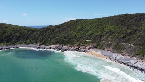 drone flying towards the rocky coastline