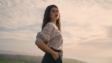 beautiful model cloudy sky summer evening. attractive woman posing at nature.