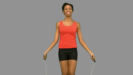 woman working out with a rope on grey screen