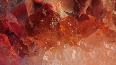 intricate details of the surface of a citrine golden quartz studio-lit against a black background