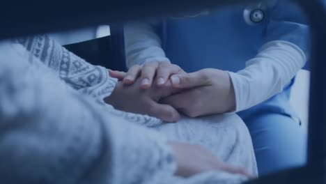 animation of structures over caucasian nurse holding hands of female patient