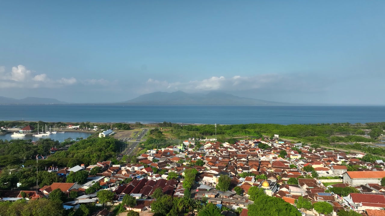 Aerial Drone Dolly In Banyuwangi Indonesia Coast Houses Fields Bali Strait Sea Landscape East Java