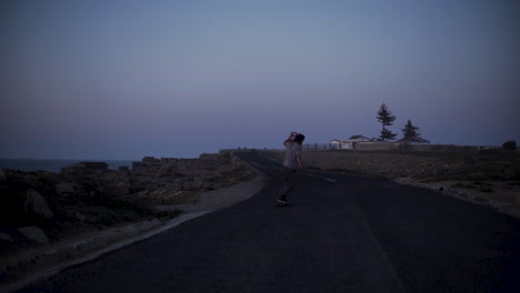 skateboarding on a coastal road at dusk