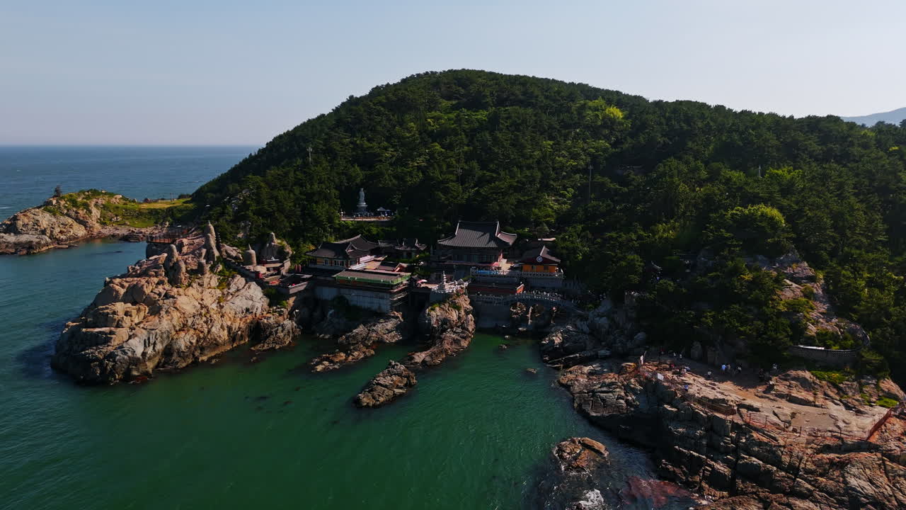 Aerial view circling the Haedong Yonggungsa Temple in sunny Busan, South Korea