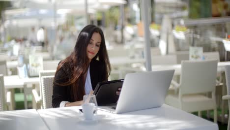 Businesswoman-making-a-call-at-a-restaurant