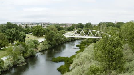 drone flight towards white bridge over stream at soto island in santa marta de tormes, salamanca, spain