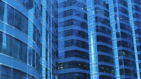 modern business architecture with glass and steel walls reflecting sky clouds