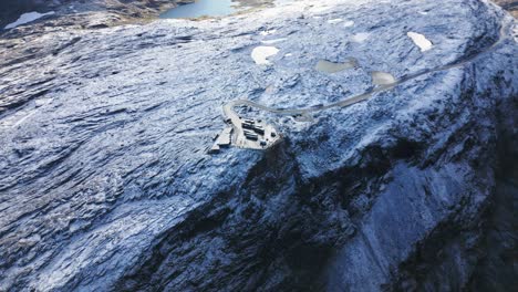 viewing-platform-on-a-snow-covered-mountain-with-several-lakes,-norway,-europe,-drone