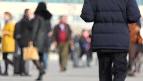 anonymous unrecognizable crowd people pedestrians walking de-focused in paris, france, europe