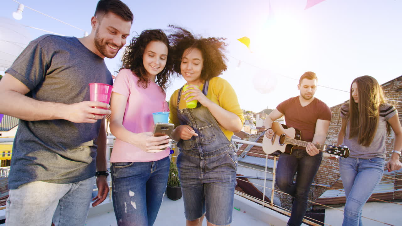 jóvenes adultos celebrando en un techo