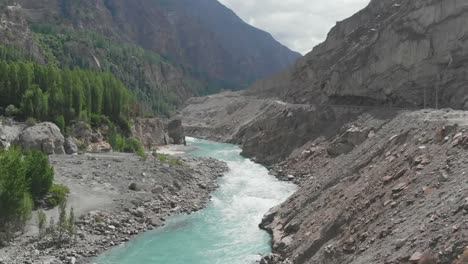 aerial over hunza river flowing through ganish valley in pakistan. dolly forward