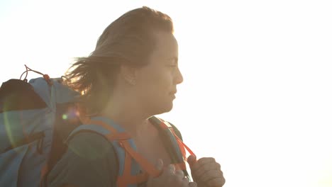 relaxed female backpacker standing outdoors