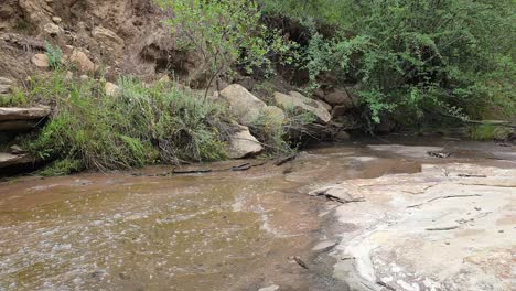 mountain spring water stream running down huge sandstone slabs of rock with green moss, algae and green plants - crystal clear drinking water, meditation tranquil and peaceful calming outdoor nature