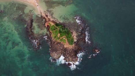 overhead shot of distinctive pigeon island surrounded by waves , mirissa sri lanka