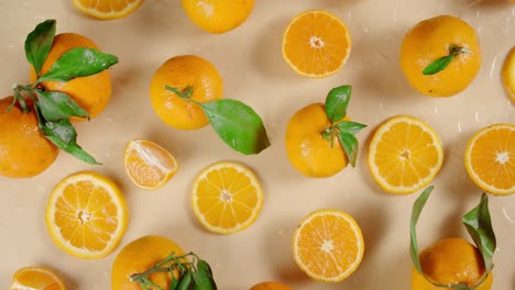 las rebanadas y las mandarinas enteras caen gotas de agua.