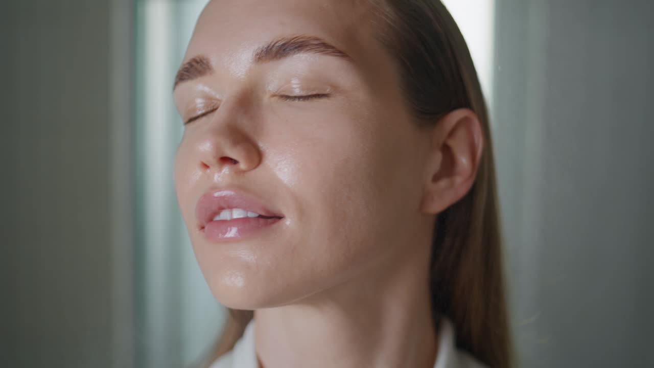Girl spraying thermal water in ideal skin. Closeup beauty model looking camera