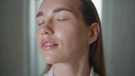 girl spraying thermal water in ideal skin. closeup beauty model looking camera