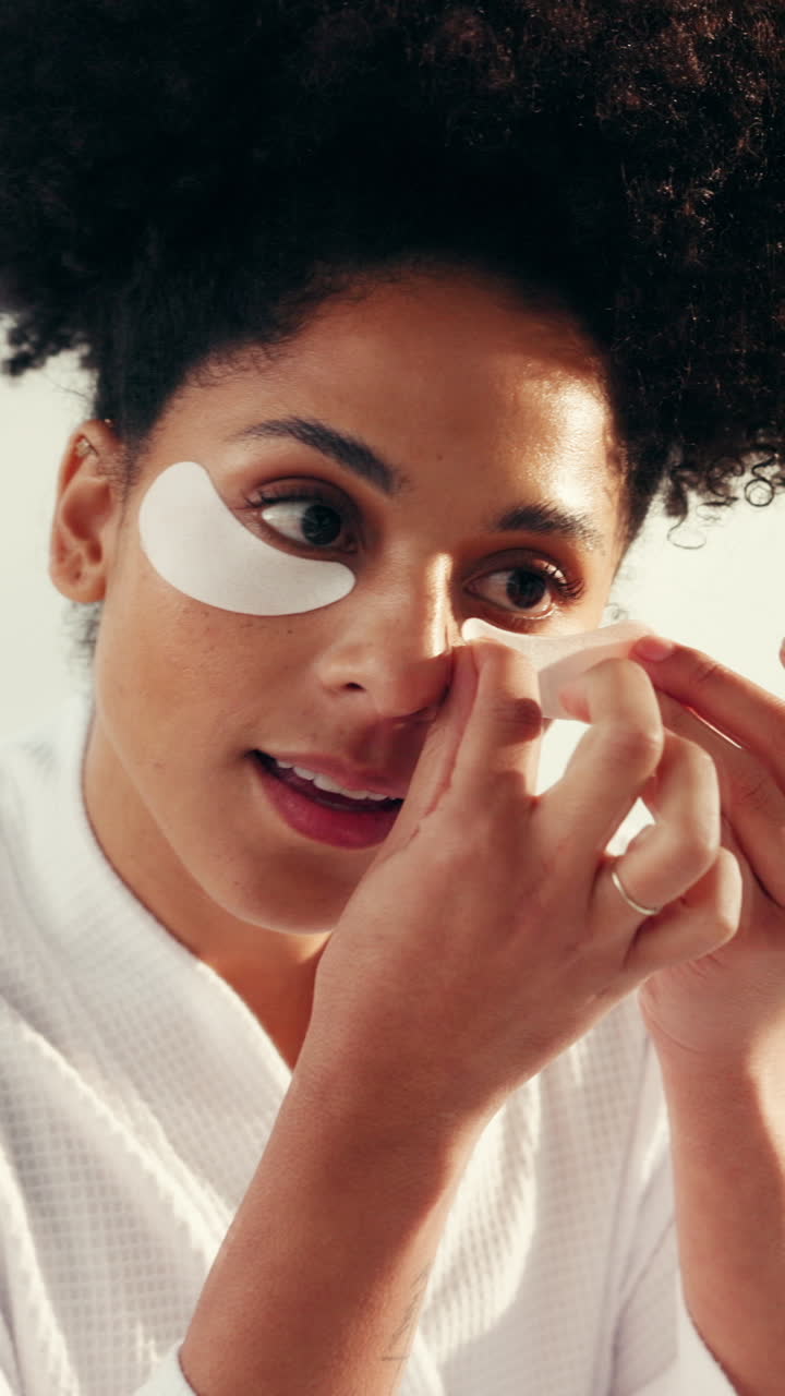 Woman applying eye patches