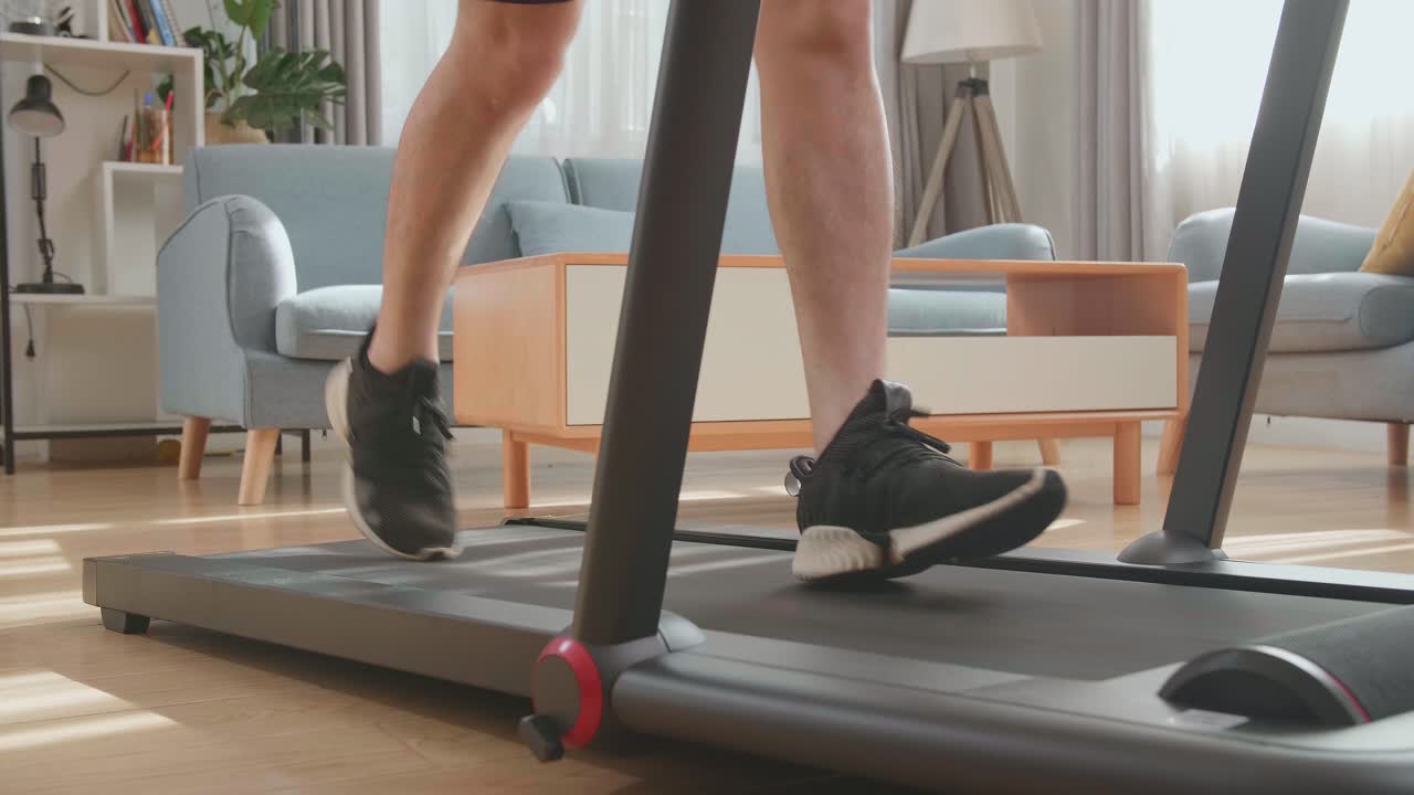 Legs Of Man Running On A Treadmill At Home
