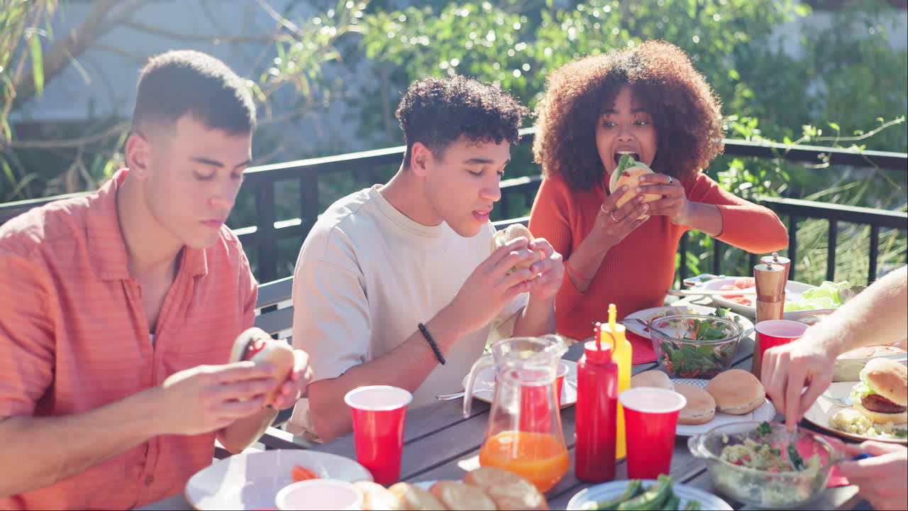 Friends enjoying hamburgers at a picnic