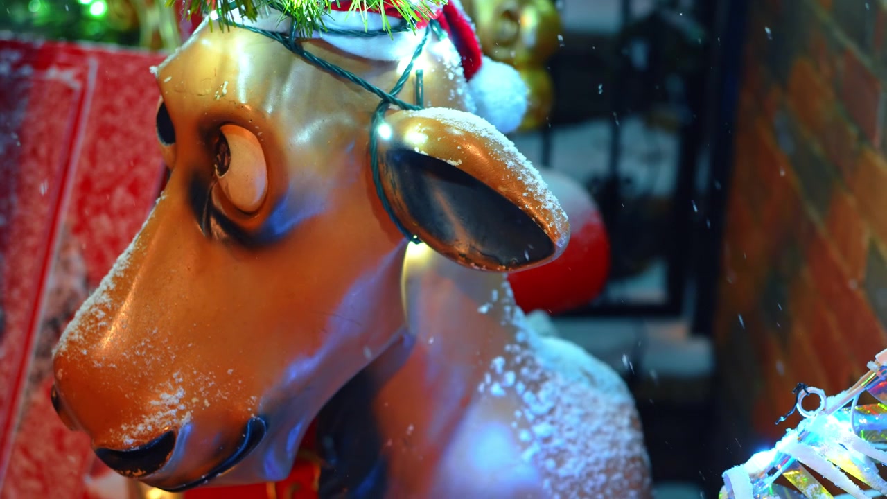New York, USA, 25 December 2025: Close up of festive reindeer decoration with snow New York. Detail of a brown plastic reindeer statue with holiday lights and snow on its head at a Christmas display.