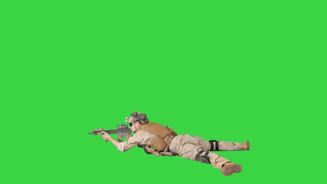 Soldier taking lying position and aiming at a target from automatic weapon on a Green Screen, Chroma Key