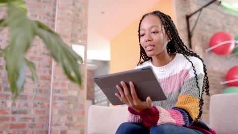 happy african american casual businesswoman using tablet in office, slow motion