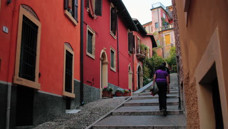 clip from a little street of verona, italy, with people walking around