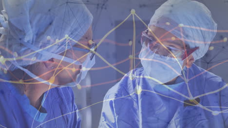 female surgeons consulting in medical operating room, displaying animated data flow network overlay