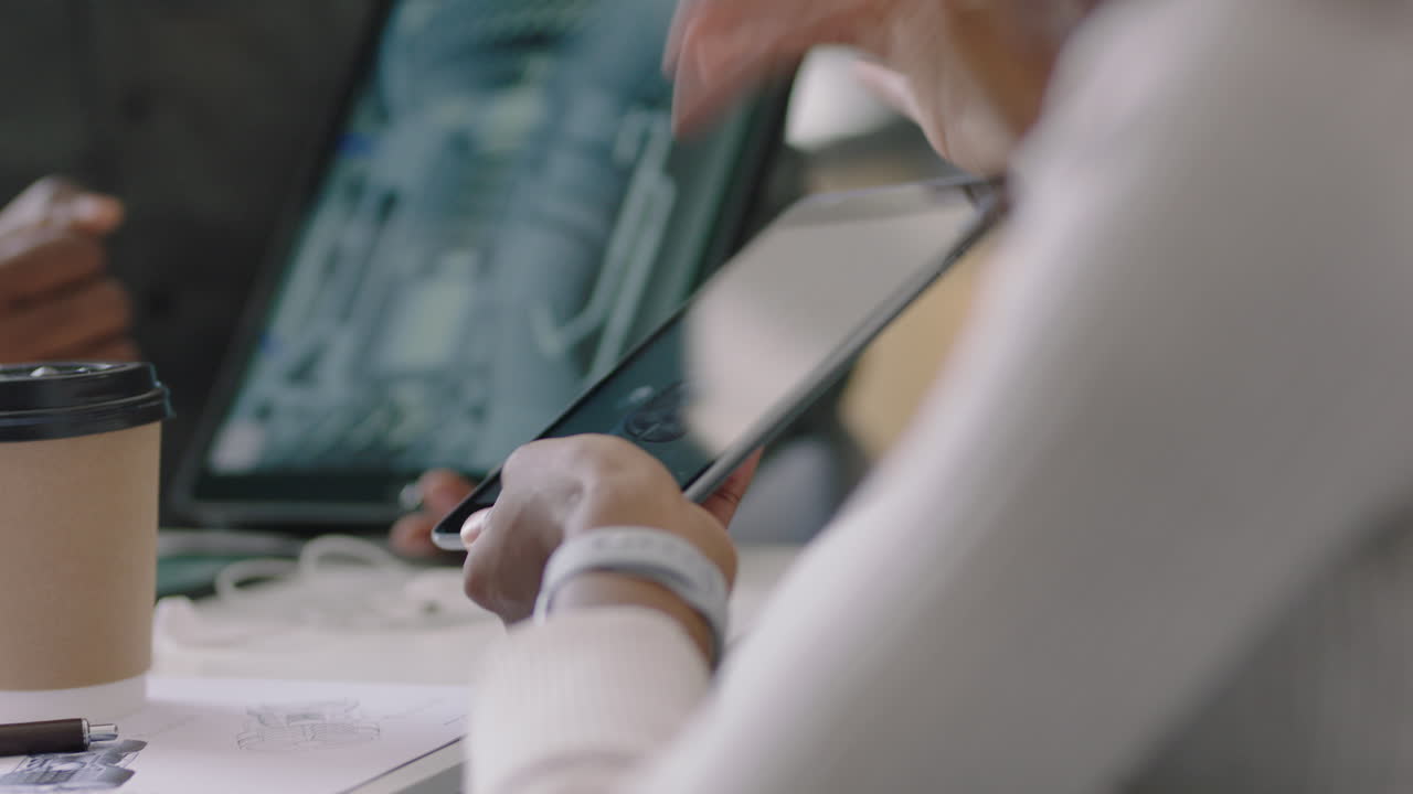 close up african american engineers developing engine turbine prototype using digital tablet computer sharing 3d design ideas on screen brainstorming mechanical project in office presentation meeting