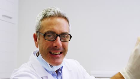 portrait of smiling dentist in dental clinic