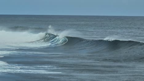 long lens drone shot of waves breaking on a reef in mauritius