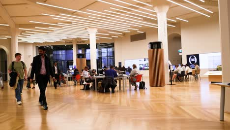 people walking and studying in library