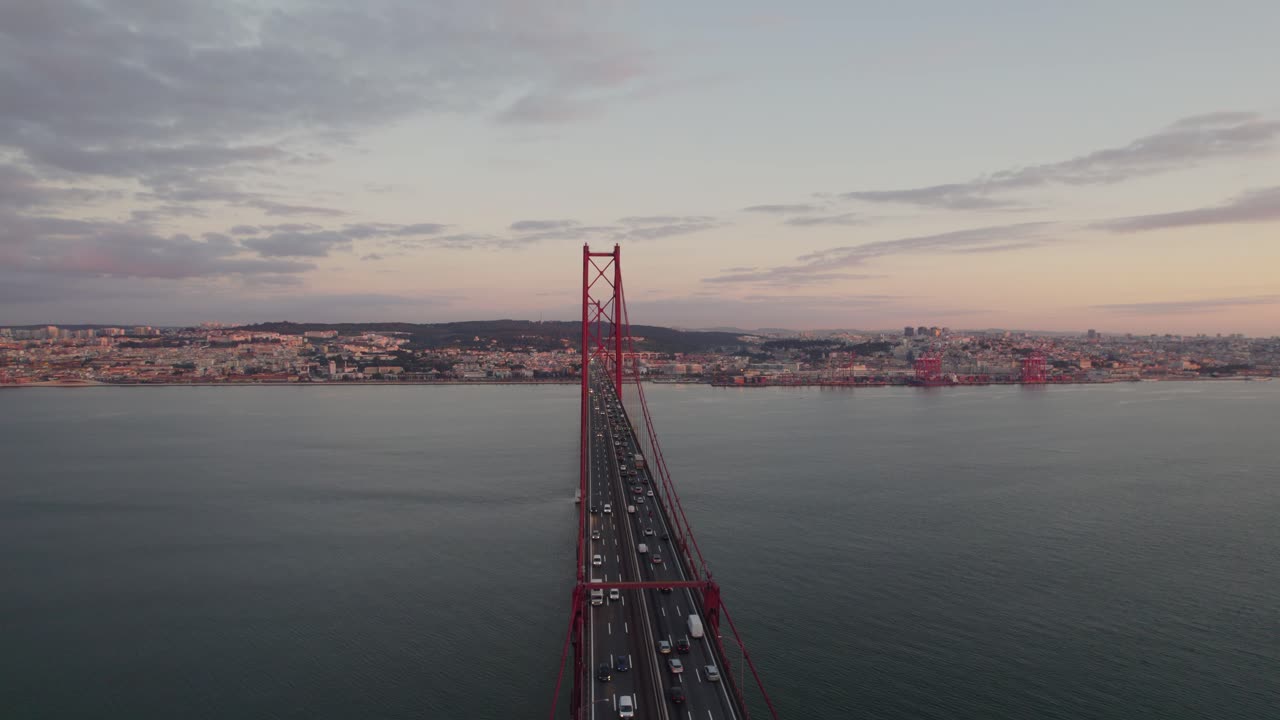 cars moving along the 25 de Abril Bridge, which spans the Tagus River in Lisbon, Portugal