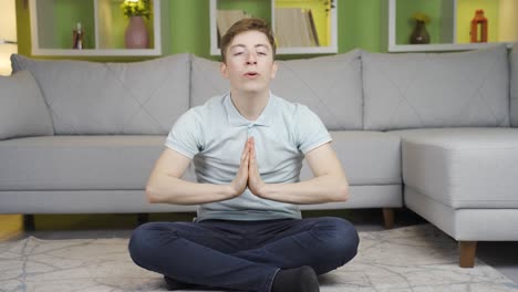 young man meditating at home.