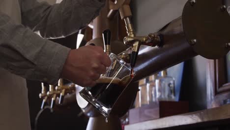 hands of a caucasian man working at a microbrewery pub