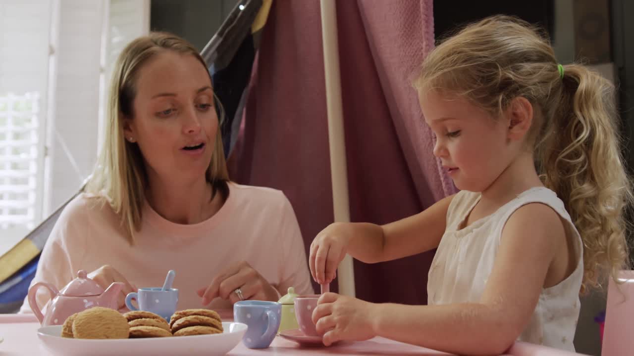 madre e hijas jugando a la cena juntas