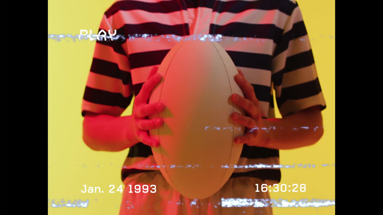 Holding rugby ball, person with animation overlay and date January 24, 1993