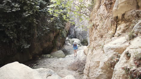 woman hiking through a canyon