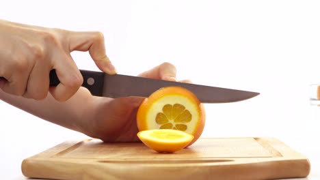 knife slicing fresh orange