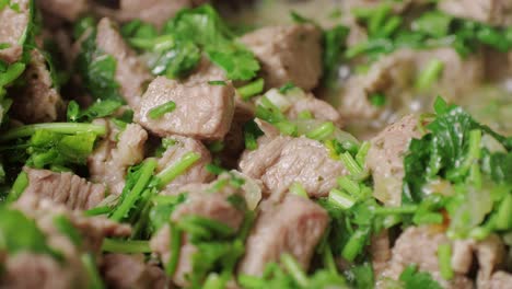 chicken or pork stew with red and green pepper onion, and spices cooking in a frying pan. traditional mexican cuisine, tacos preparation, ragout.