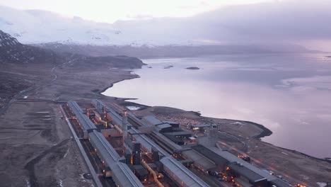 alcoa fjardaál aluminium smelter factory in iceland during sunrise, aerial