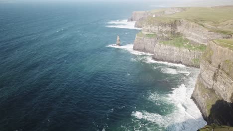 drone scenic view of cliffs of moher during a sunrise next to the atlantic ocean, ireland