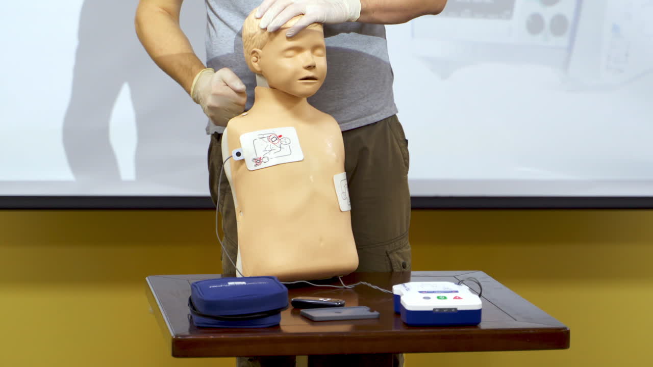 Medical training on a manikin. Instructor demonstrating the procedure of first aid on a dummy. Cardiopulmonary resuscitation.