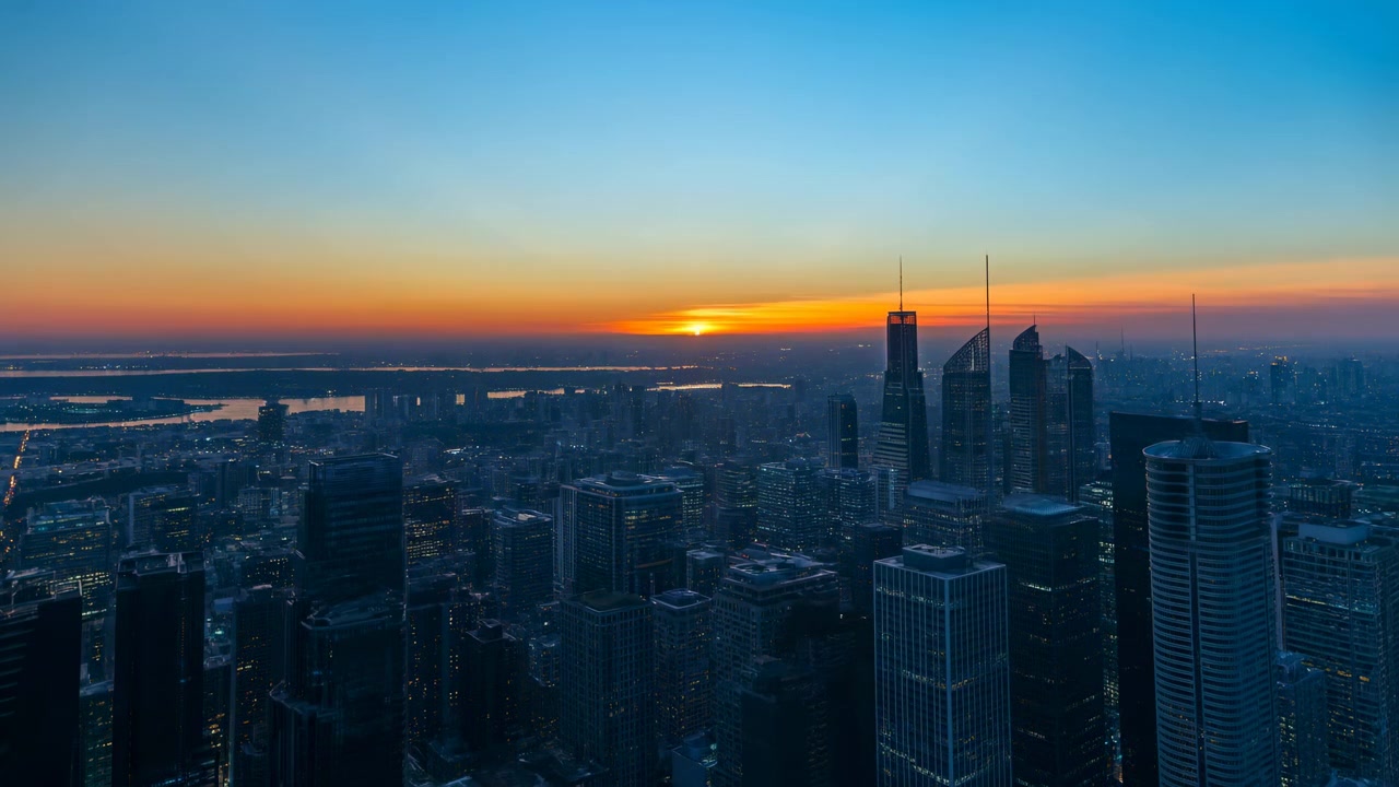 Una vista aerea mozzafiato di un tramonto sereno su un vivace paesaggio urbano al crepuscolo, con grattacieli a specchio e strutture in cemento, che cattura l'atmosfera tranquilla e moderna