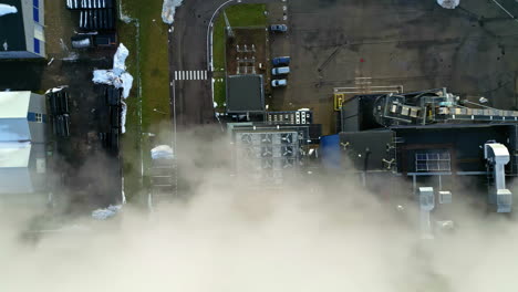 steam and smoke emissions from a district teleheating plant - straight down aerial view