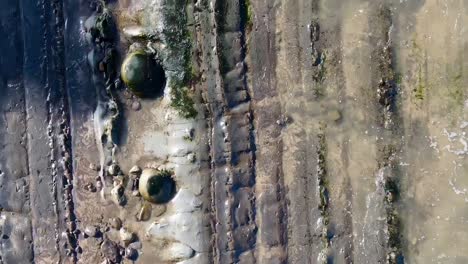 Drone-video-of-muddy-stones-chased-by-the-river-in-Bodega-Bay-and-Gualala-Coast