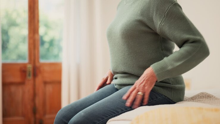 Closeup, woman and pain of back