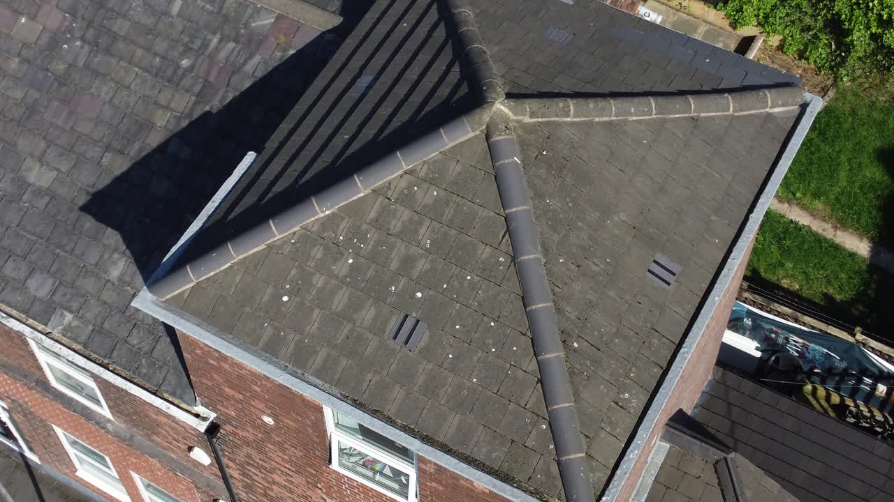 Inspection aerial view inspecting rooftop damage and repair of real estate for homeowner