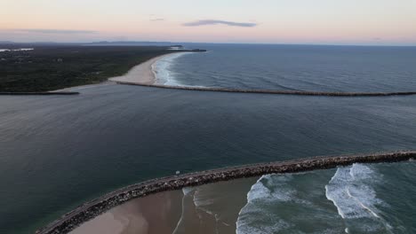 clarence river mouth between the iluka break wall and yamba breakwater during sunset